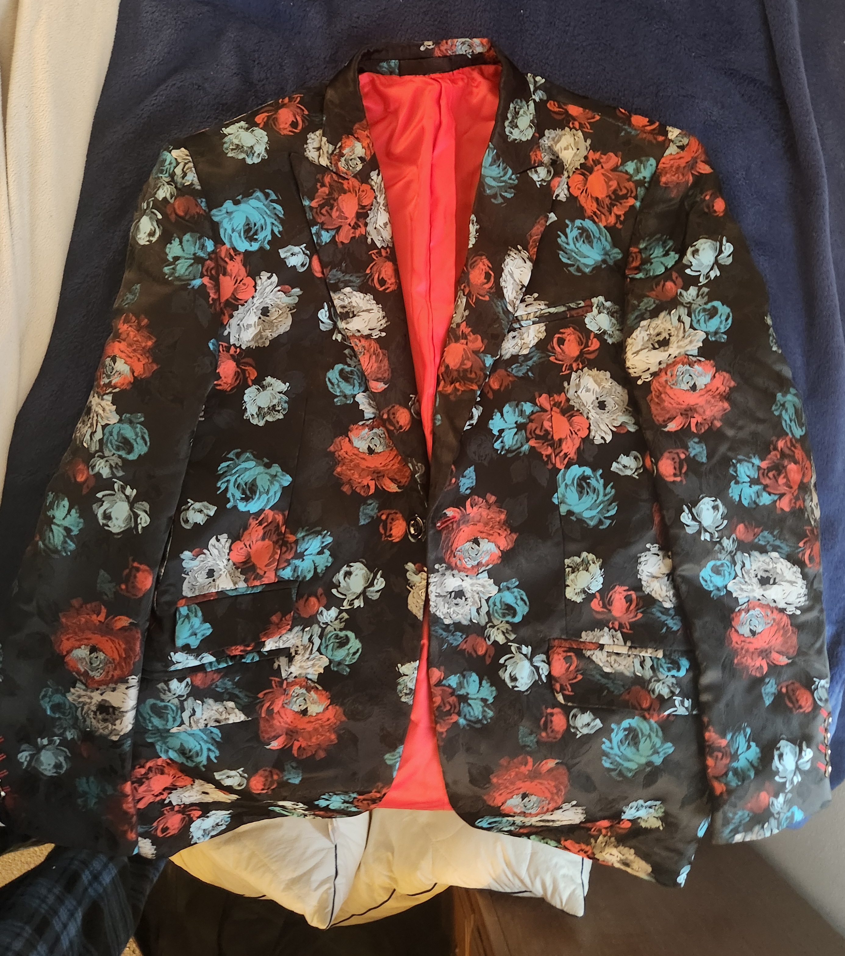 Blue and red floral printed jacket on black background with red lining